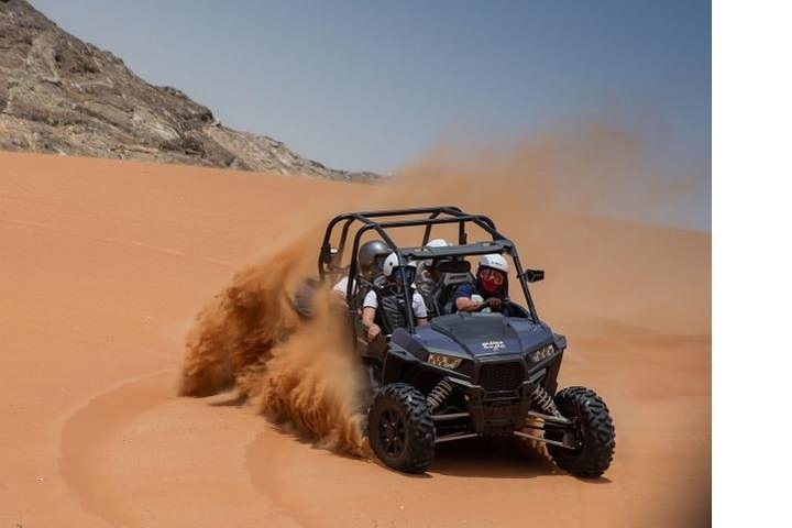 Experience the stunning Mleiha Desert as you race across its golden sands discovering unique rock formations like Camel Rock and Fossil Rock on an unforgettable adventure.